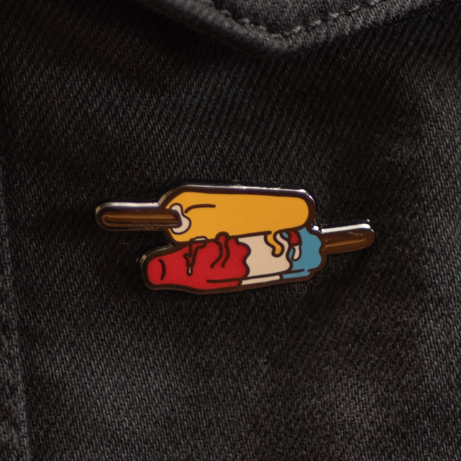 Colorful pin on a black denim jacket