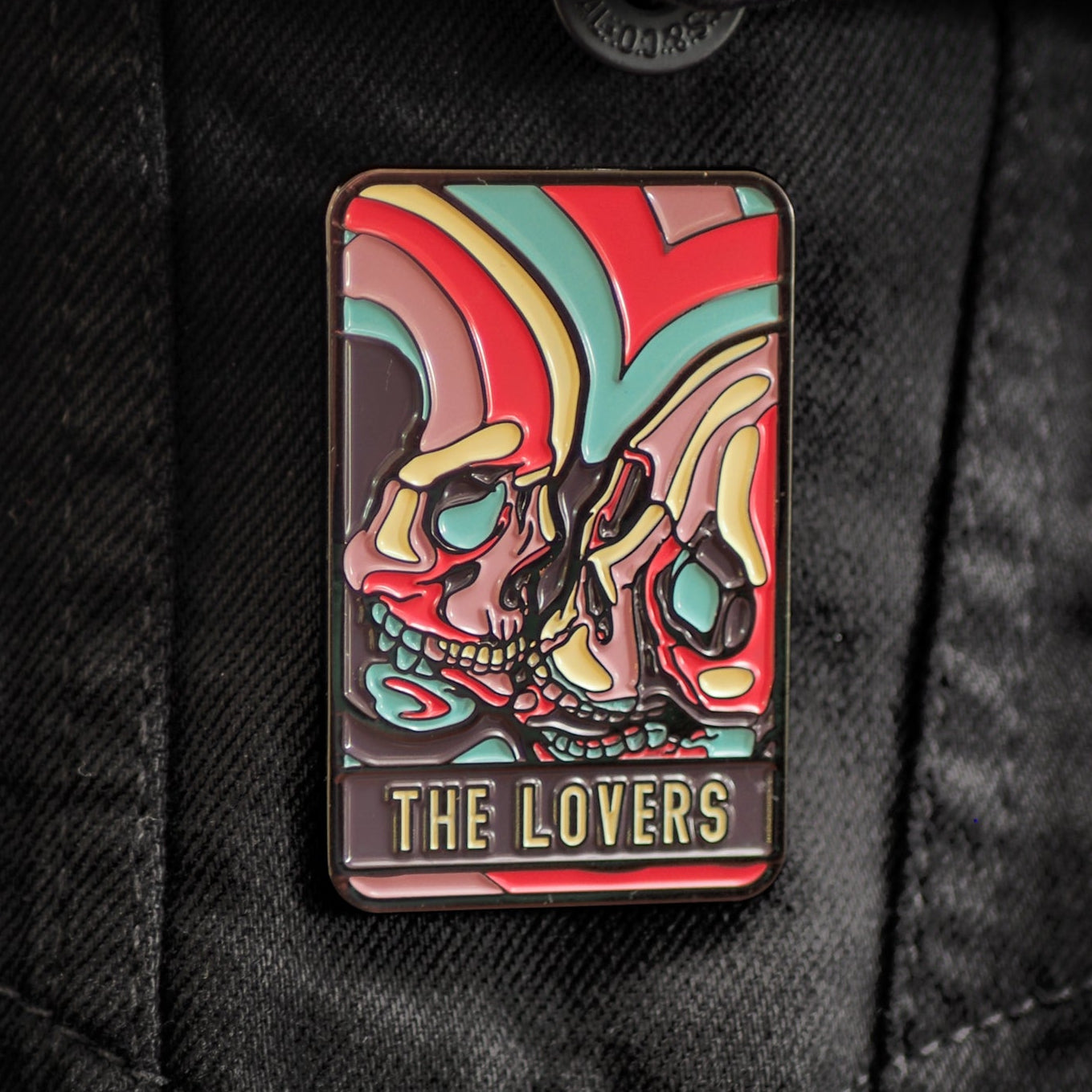 Colorful 'The Lovers' pin on a black jacket