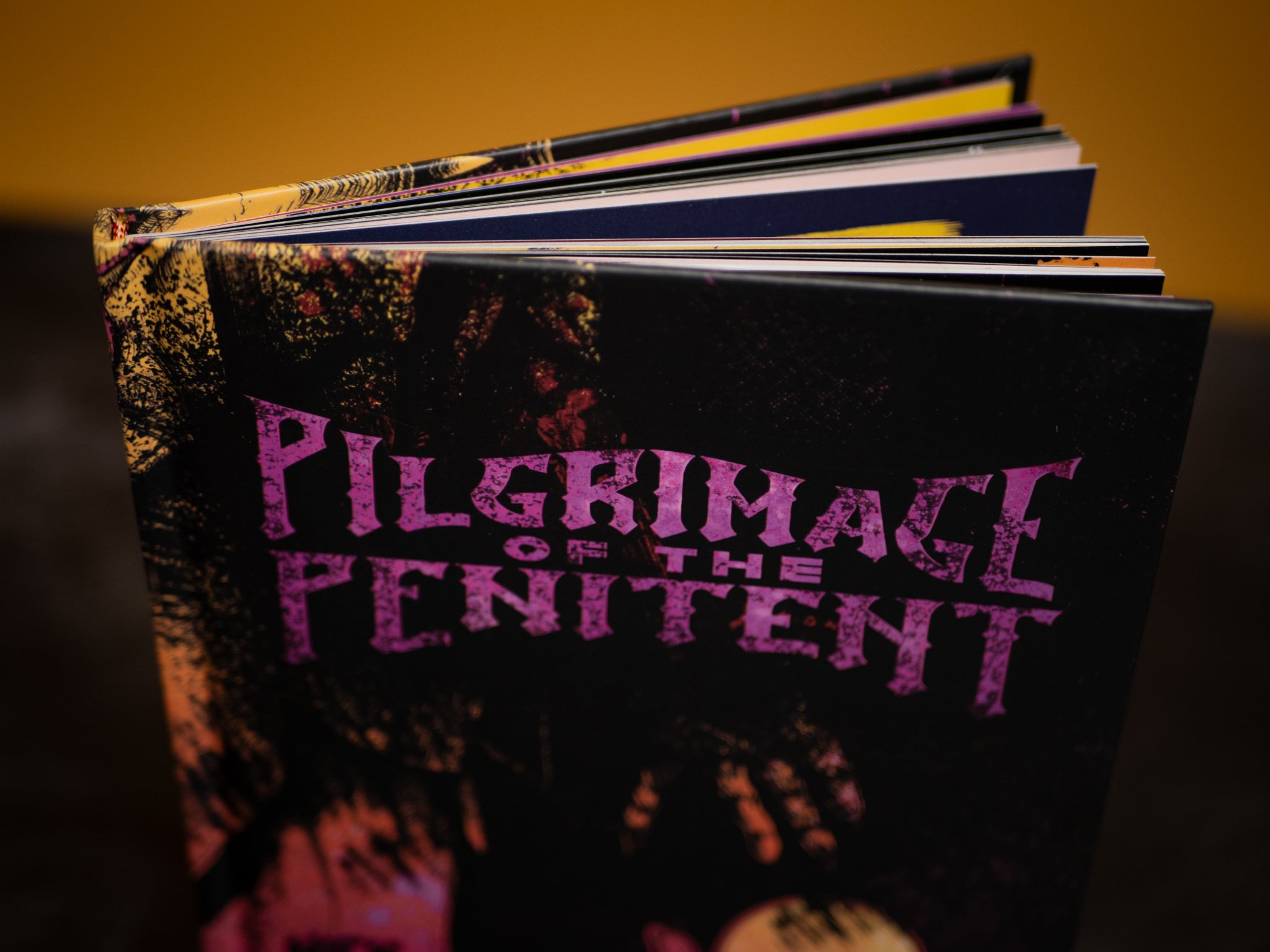 Book titled 'Pilgrimage of the Penitent' with a dark cover and purple text.
