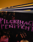 Book titled 'Pilgrimage of the Penitent' with a dark cover and purple text.