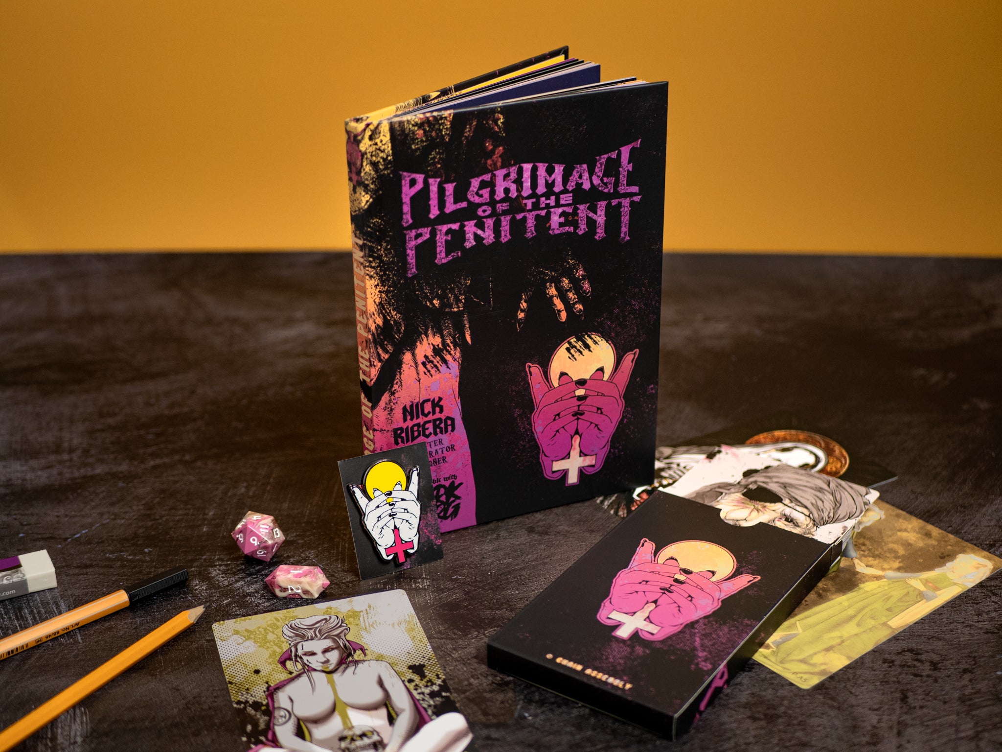 Book titled 'Pilgrimage of the Penitent' with artistic covers on a dark surface.