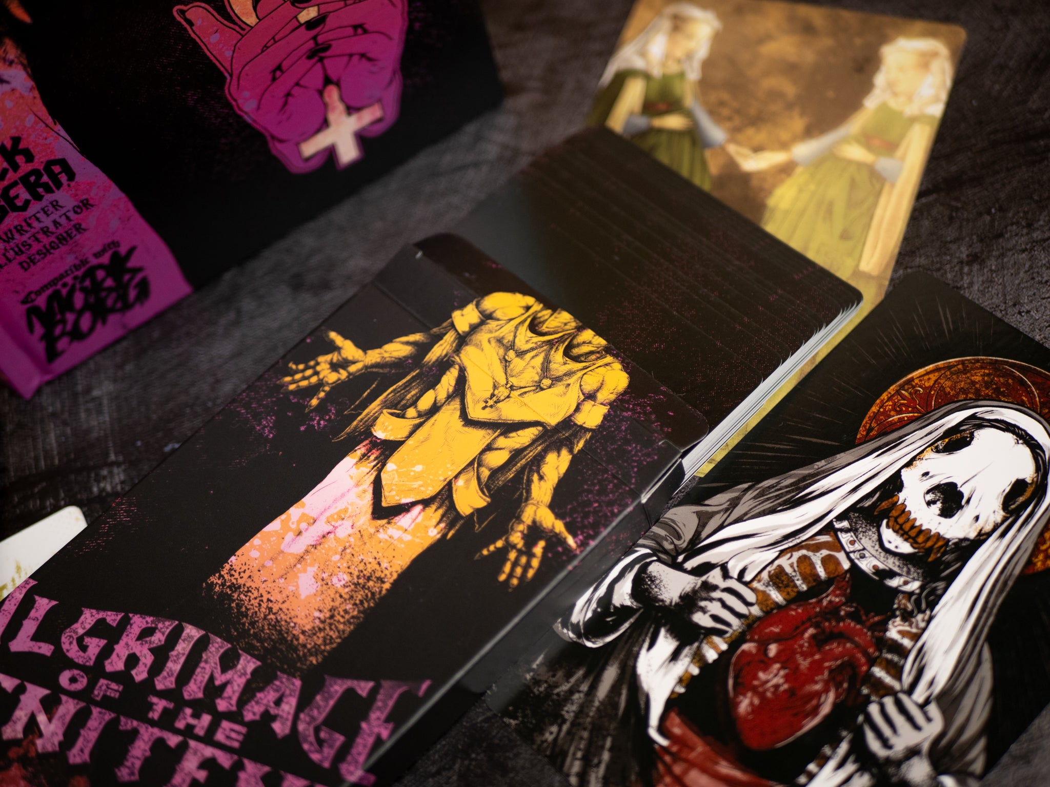 Collection of graphic cards with artistic designs on a dark surface