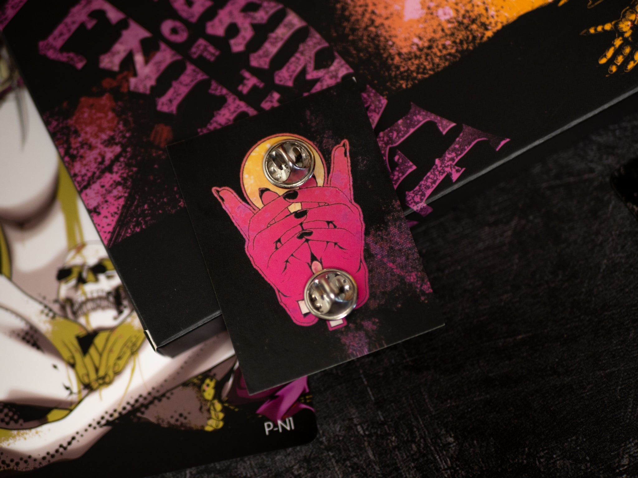 Pink hand with a yellow circle and black lines on a black card with text, against a dark background.