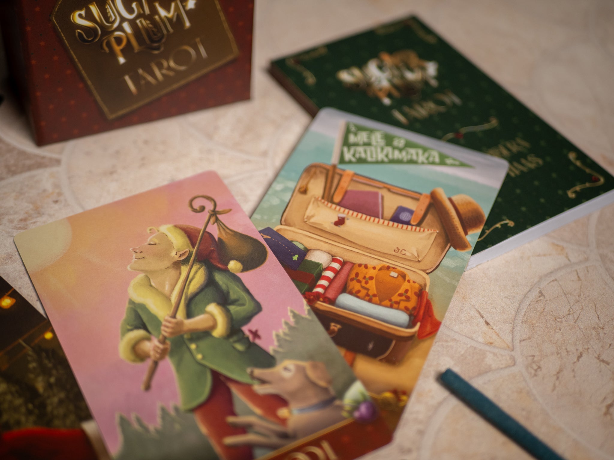 Close-up of tarot cards with a focus on a card featuring a character with a violin and a suitcase.