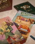 Close-up of tarot cards with a focus on a card featuring a character with a violin and a suitcase.