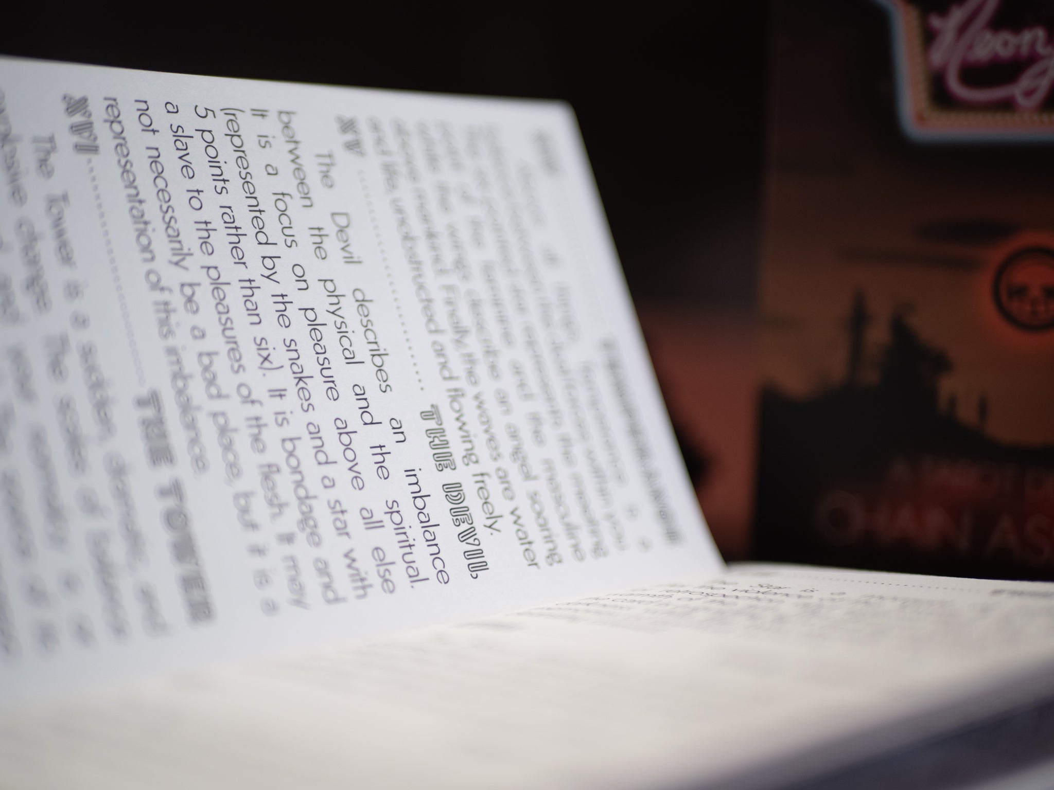 Close-up of a book with text and a blurred background