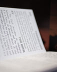 Close-up of a book with text and a blurred background