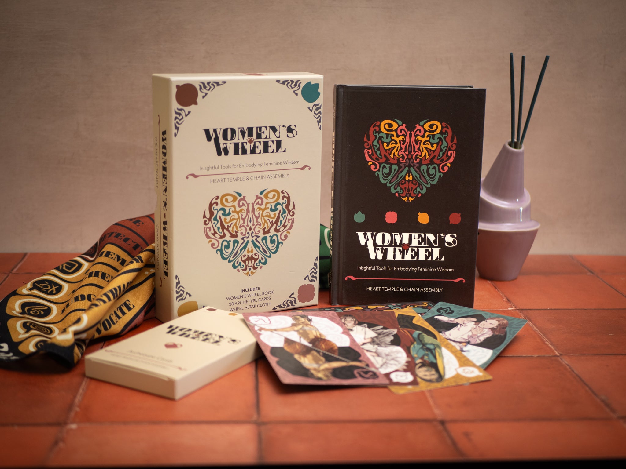 Two books titled 'Women's Week' on a tiled surface with decorative elements.
